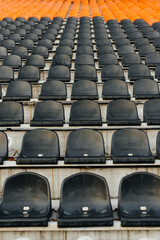 Naklejka premium Empty stands and seats for fans and fans in the open-air stadium. Lack of fans during the pandemic.