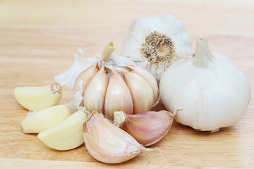 White raw garlic on brown wood floor