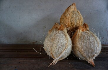 Some old coconuts that have been opened are on the trasitional chocolate table