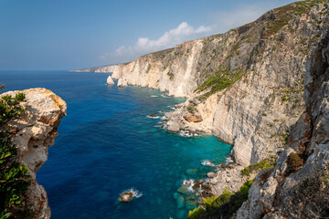 Fototapeta premium Famous cliff rock, sea, celar blue water, nature in Zakynthos Ionian island, Greece. Amazing view with multicolored clouds, clear sky. Island of lovers. Doors to heaven.