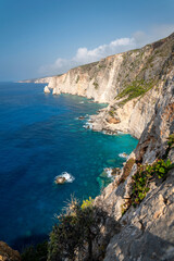 Fototapeta na wymiar Famous cliff rock, sea, celar blue water, nature in Zakynthos Ionian island, Greece. Amazing view with multicolored clouds, clear sky. Island of lovers. Doors to heaven.