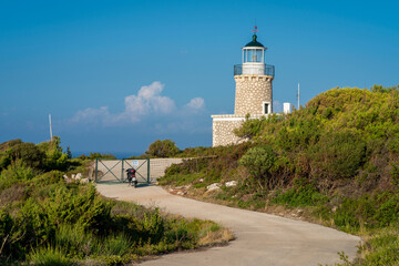 Fototapeta na wymiar Skinari Lighthouse located at the northern cape of Zakynthos island in Greece. Zante, near Korithi above Cape Skinari. Summer, day time, sunset..good vibe.