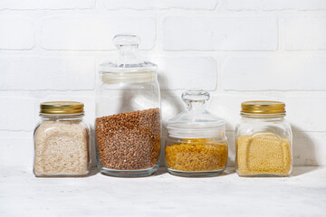 cereals in glass jars on a white background