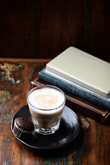 Coffee with milk on rustic wooden background. Soft focus.