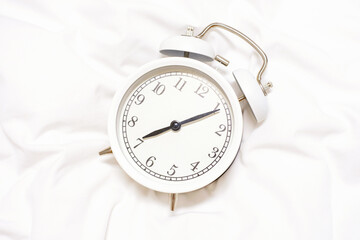 Alarm clock on white background close-up, early rise concept.