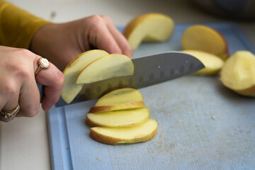 slicing apple on a chopping board