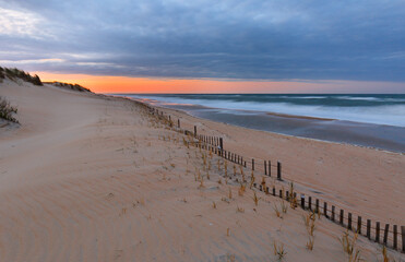 Beautiful sunset at Outer Banks beach viewing from Jennette's Pier, Nags Head, North Carolina, USA.