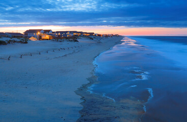 Beautiful sunset at Outer Banks beach viewing from Jennette's Pier, Nags Head, North Carolina, USA.