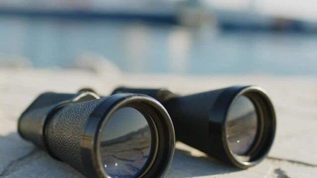 Binoculars of the harbor master's office with blurred ship in the background