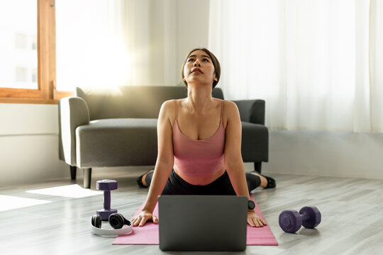 Fitness Instructor Having Virtual Yoga Class Using Video Call On Laptop. Remote Yoga Teacher Leads A Lesson For People