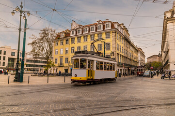 Naklejka na ściany i meble A view of public transport in a square in the Bairro Alto distict in the city of Lisbon on a spring day