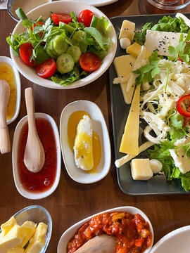 traditional turkish breakfast table with variety of cheese, olive, jam