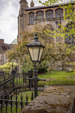 Victorian style street lamp with an old and historic church in the background