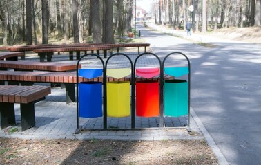 Multi-colored containers for separate garbage collection in the park.