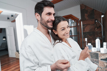 Male laughing with his wife during brushing of teeth