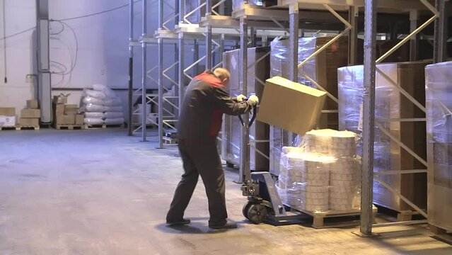 Injury at work. Warehouse worker lying unconscious on the concrete floor after the fall. Dangerous accident at the warehouse. Logistics and safety concept.