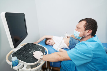 Caucasian medical worker conducting an examination of internal organs