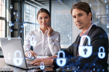 Businessman and businesswoman working together to protect clients confidential information and...