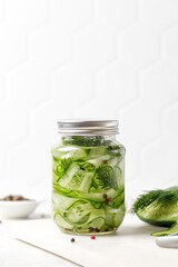 Jar of Pickled cucumbers. Slices of Marinated cucumbers in glass jars. Homemade fermented cucumbers.
