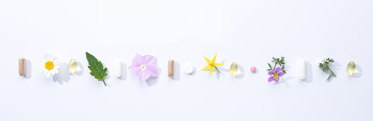 Vitamin capsules and dietary supplements isolated on with background . Panoramic format.