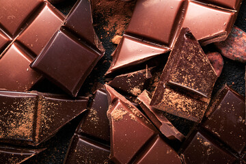 Chocolate pieces. Composition of bars and pieces of different milk and dark chocolate, grated and...