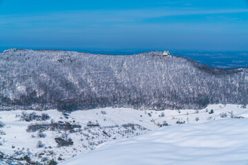Germany, Castle teck on swabian alb mountain teckberg covered by snow in winter wonderland nature landscape scene, magical panorama view on sunny day