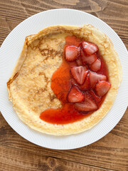 Pancake with strawberry jam. Top view