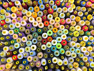 Sewing threads colorful background closeup