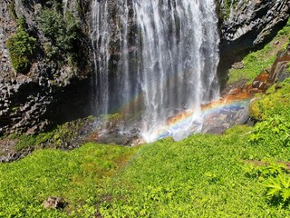 A waterfall is even more enchanting by the rainbow at the bottom.