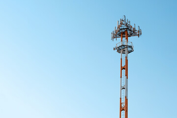 Telecommunication tower on the blue sky background
