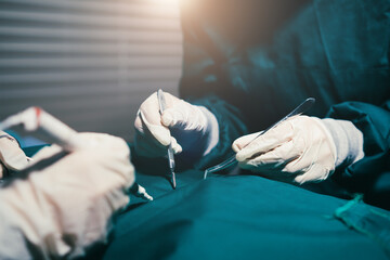 Surgical procedure close up doctors hand performing surgery on patients health, surgeon in scrubs...