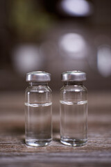 two closed ampoules with a clear liquid without a label