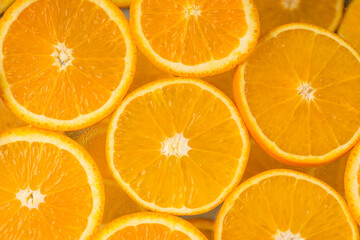 Closeup of juicy citrus fruits. Orange slices on a light background. Top view. Healthy natural product.