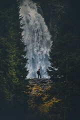 Man standing in front of  Big Waterfall - Krimmler Waterfall in Austria