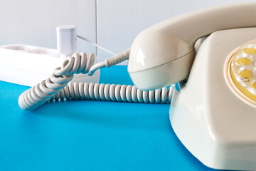 Old technology telephone connected to the electrical network through a plug