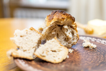 commercial shots, a girl baked bread, she cuts it with a knife, breaks it with her hands, sniffs it, it smells wonderful. association with childhood and parental home. Prores422.