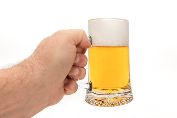 Male hand holding a refreshing mug of beer