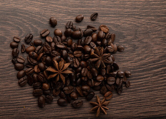 Coffee beans and star anise on a dark wood background
