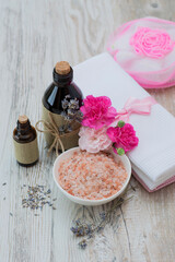 sea salt with lavender oil on a wooden background.