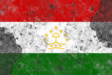 Tajikistan flag on a damaged old concrete wall surface