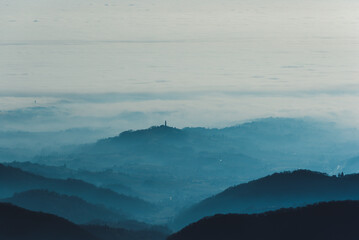 Fototapeta premium Foggy hills landscape in Italy