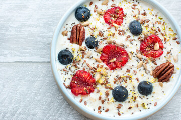 Oatmeal porridge with raspberries and blueberries. Vitamin breakfast