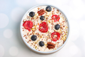 Oatmeal porridge with raspberries and blueberries. Vitamin breakfast