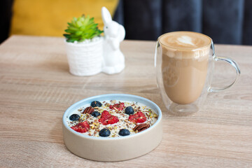 Oatmeal porridge with raspberries and blueberries. Vitamin breakfast