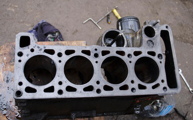 An auto mechanic is working on a car engine in a mechanics garage. Repair service. authentic close-up shot. VAZ 2106