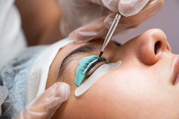 Close-up portrait of a woman on eyelash lamination procedure. 