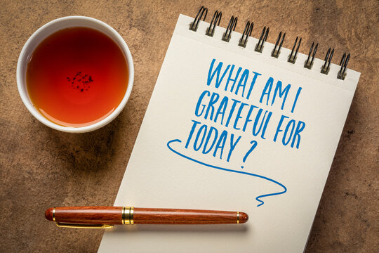 what am I grateful for today  - inspirational question in a notebook with a cup of tea, gratitude and personal development concept