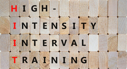 HIIT high-intensity interval training symbol. Concept words HIIT high-intensity interval training on blocks on beautiful wooden background. HIIT high-intensity interval training concept. Copy space.