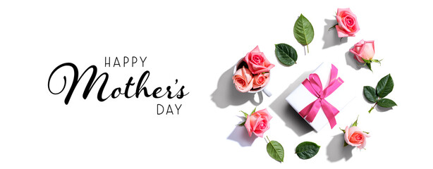 Happy mothers day message with a gift box and roses - flat lay