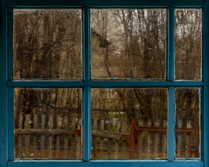 Window of an old house in the village in rainy weather.